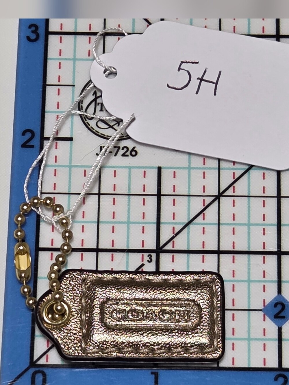 COACH Metallic Gold Leather Mini Hang Tag